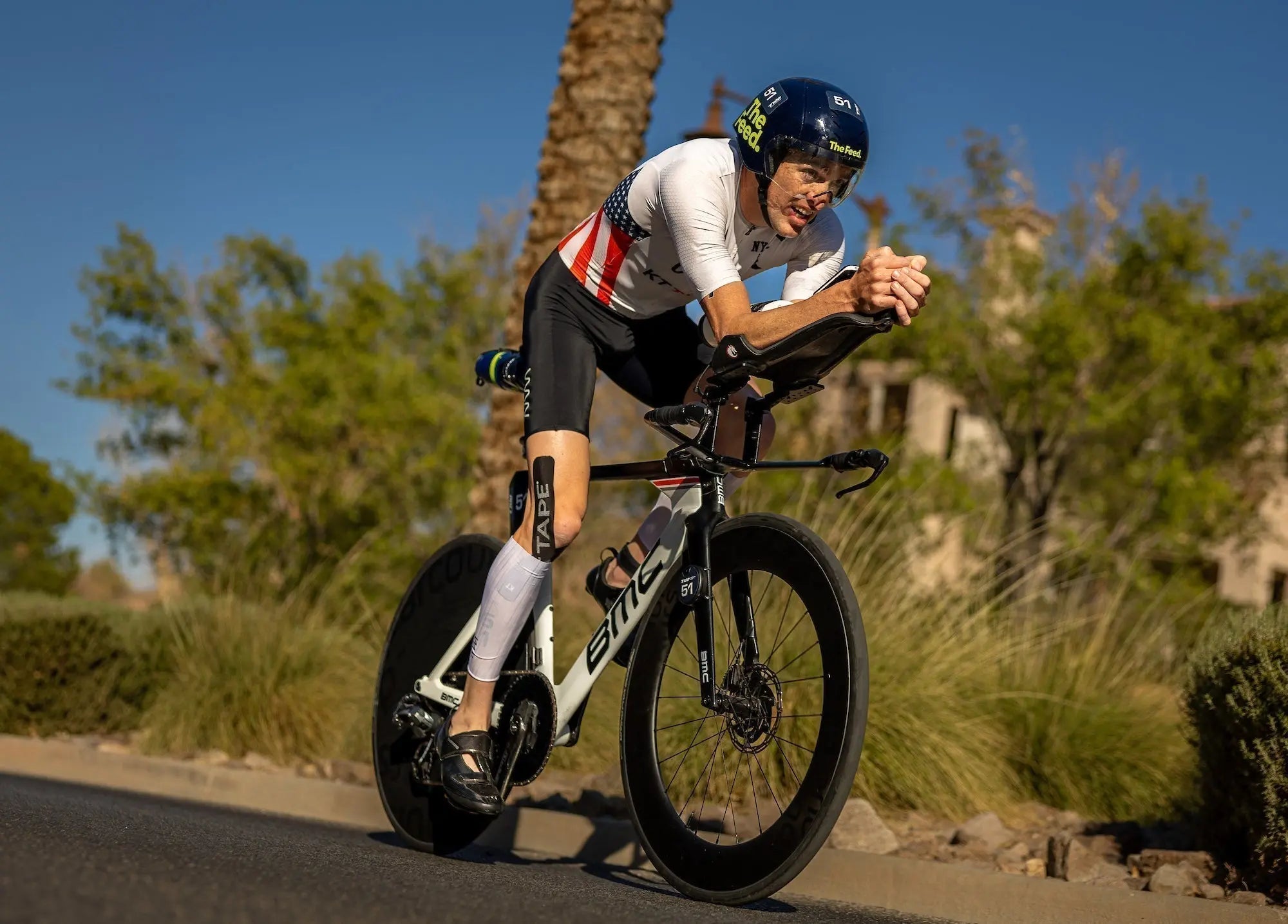 professional triathlete matt mcelroy training on road bike with kt tape on knee