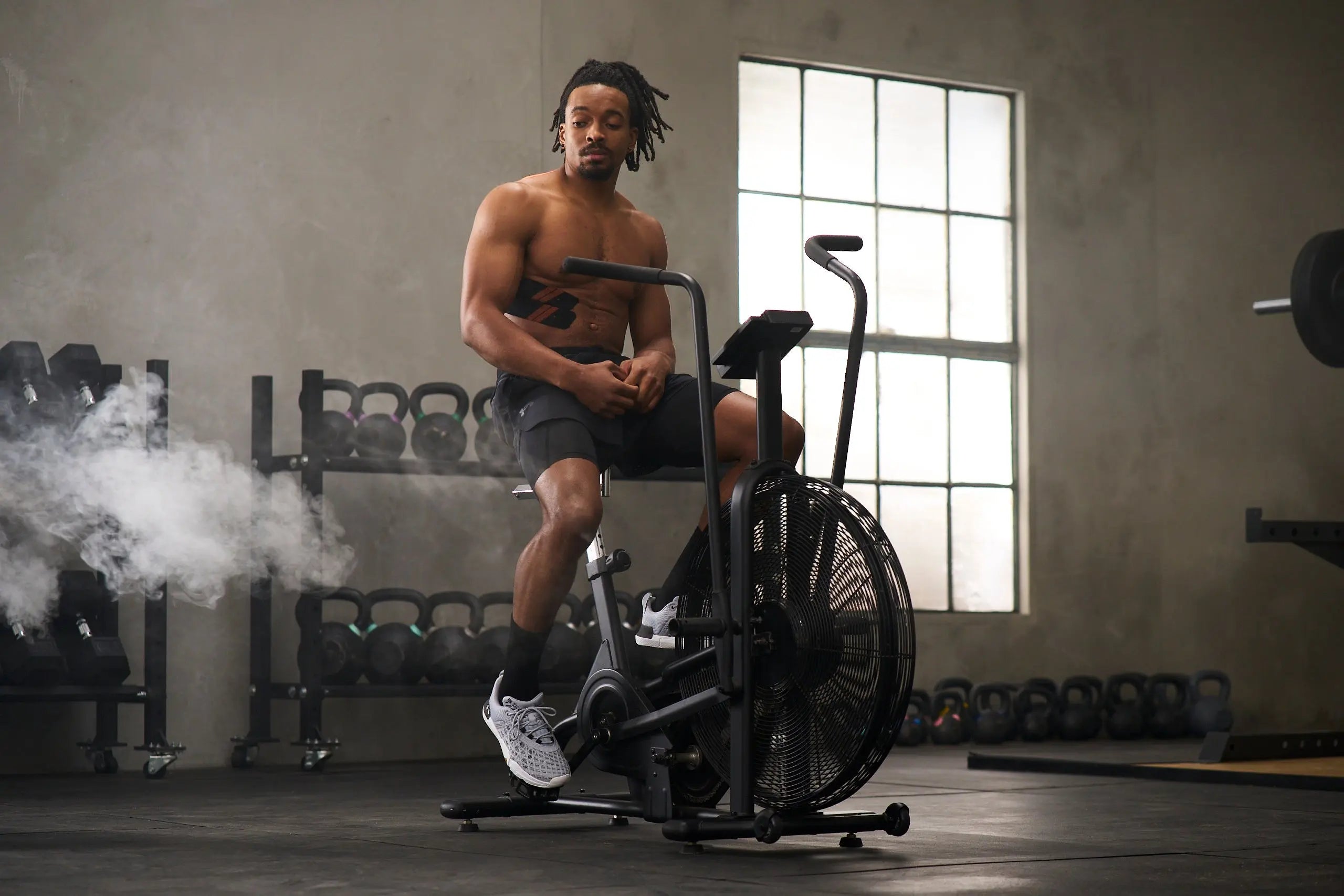 man on workout bike with kt tape for sore ribs