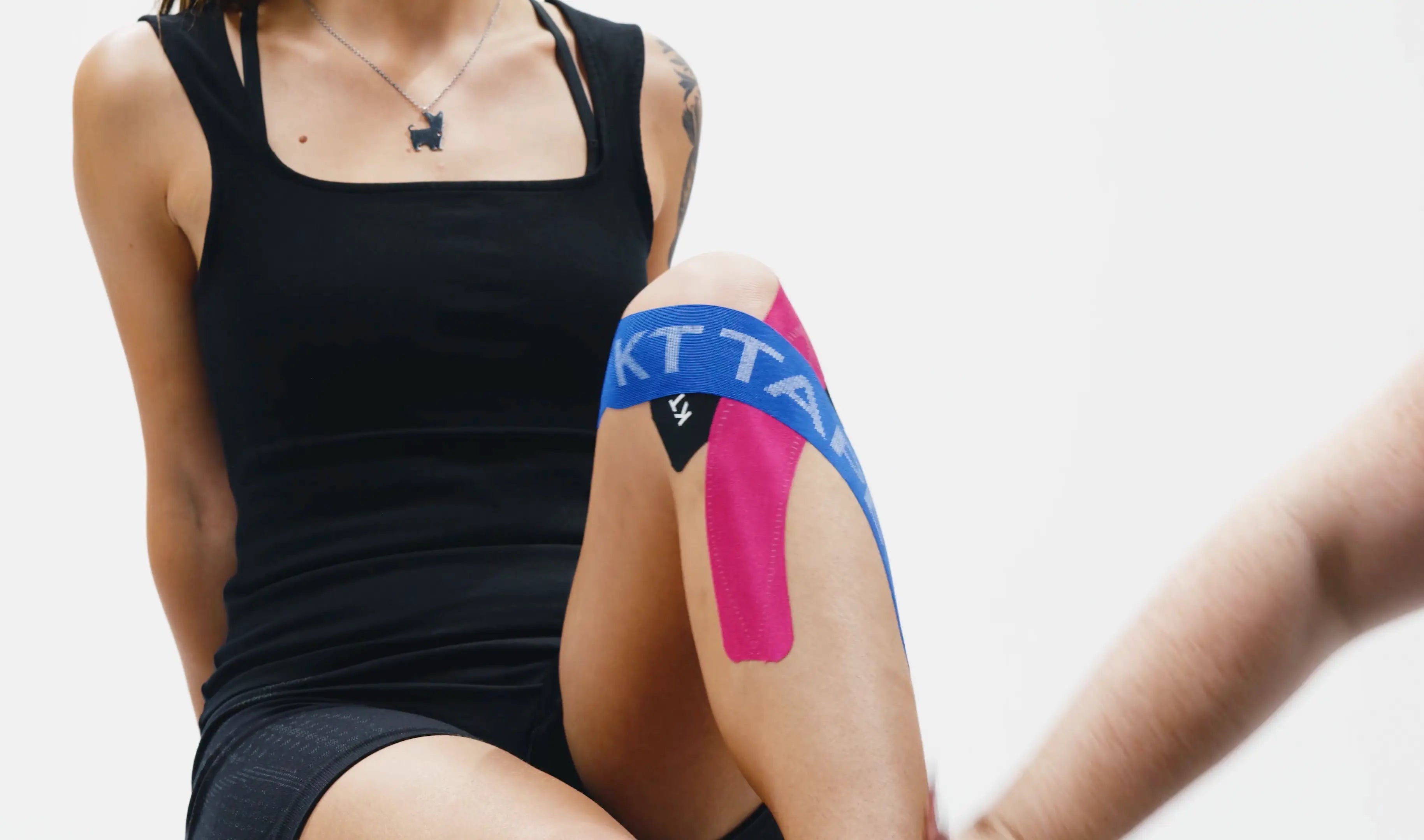Woman wearing blue KT Tape and Pink KT Kinesiology Tape