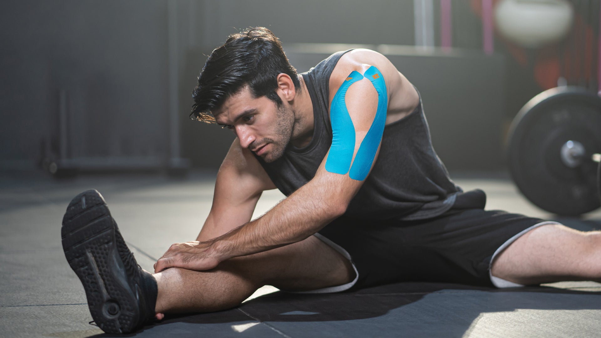 Man in gym stretching before workout
