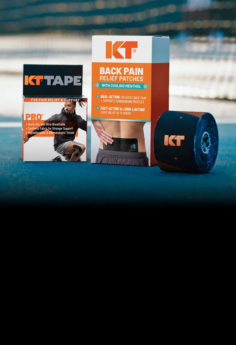 KT Tape products including tape, patches, and a roll on a blue surface with blurred background